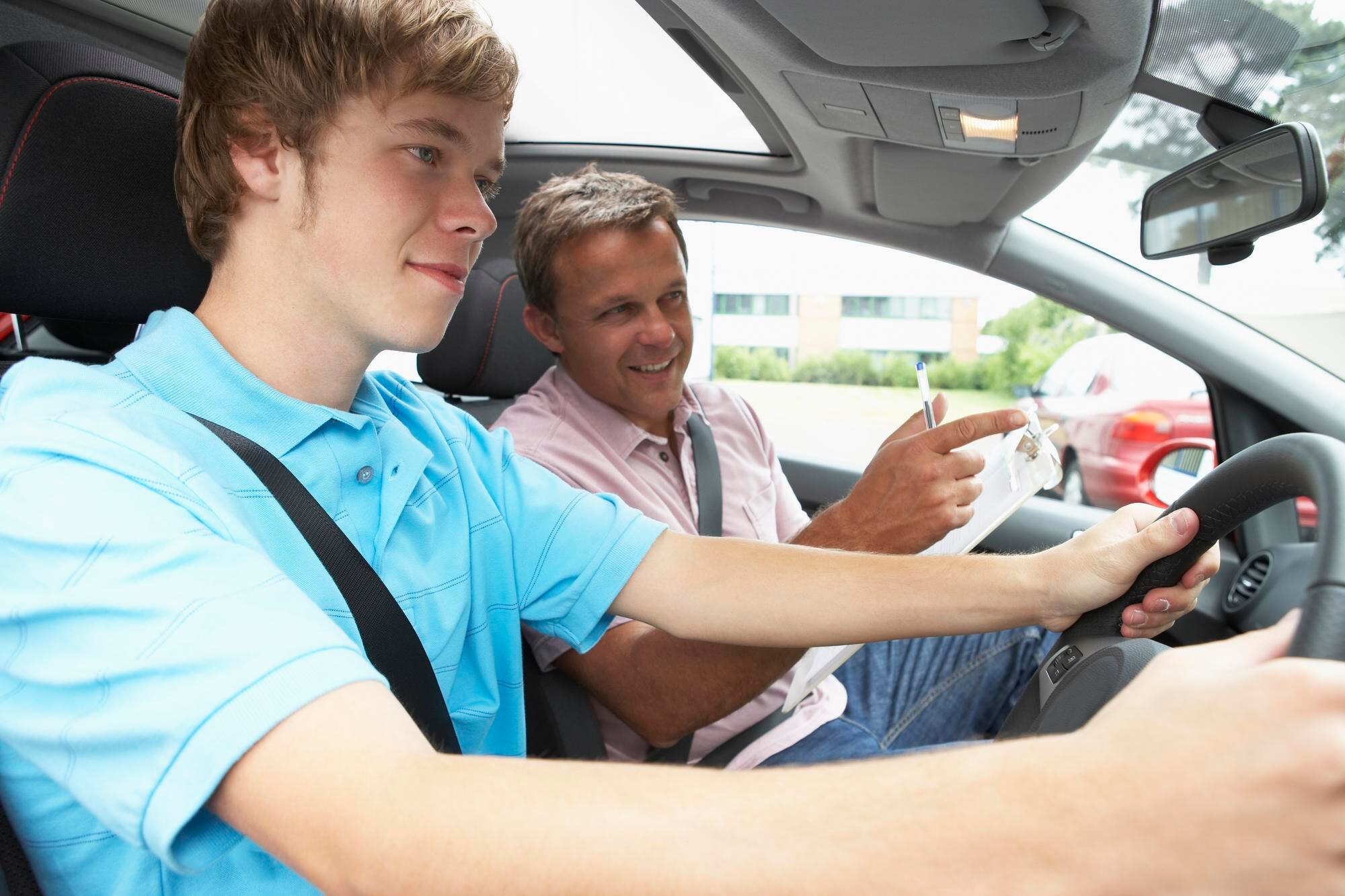 teenage boy taking driving lesson with instructor 1218270 5603